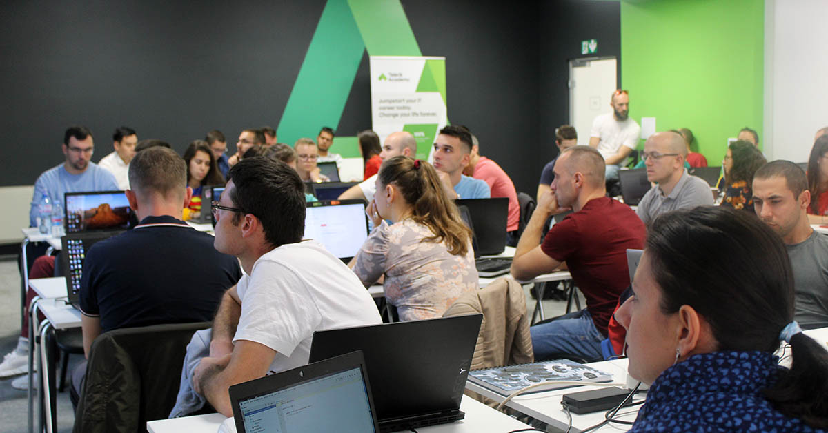 Students in a classroom with laptops learning to code at telerik academy