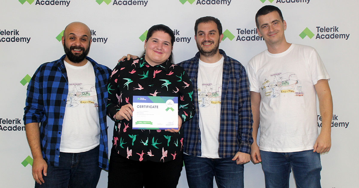 A Telerik Academy graduate posing with her diploma in the company of her trainers