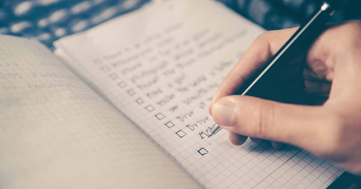 A person making a list in a notebook