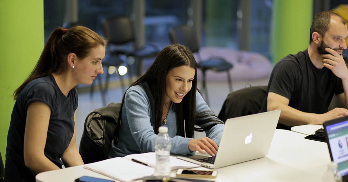 Students in front of a computer learning to code at telerik academy