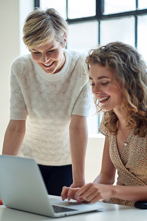 two-business-women-using-laptop